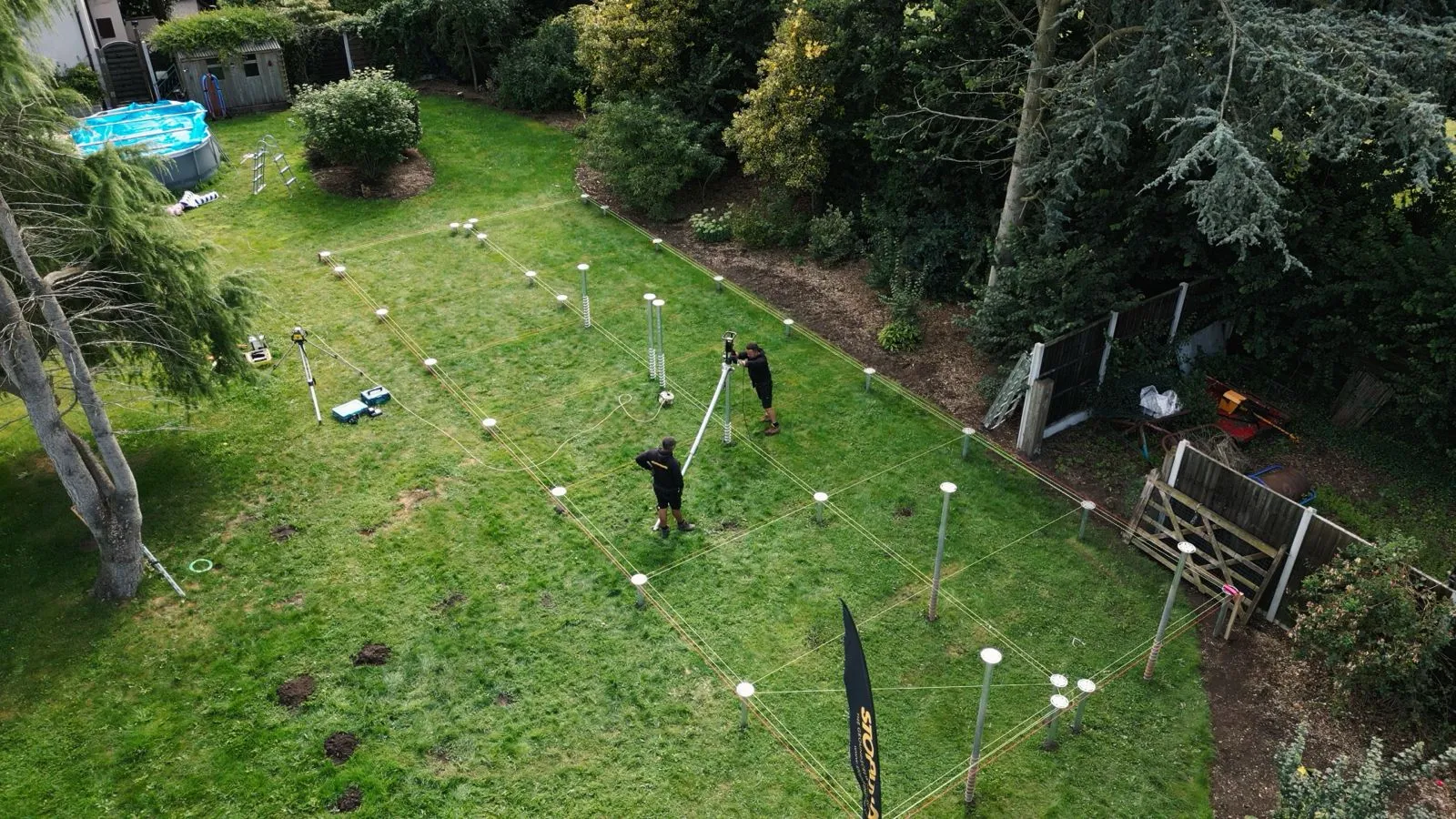 Aerial view of a Crown Pavilions ground-screw foundation grid laid in a garden